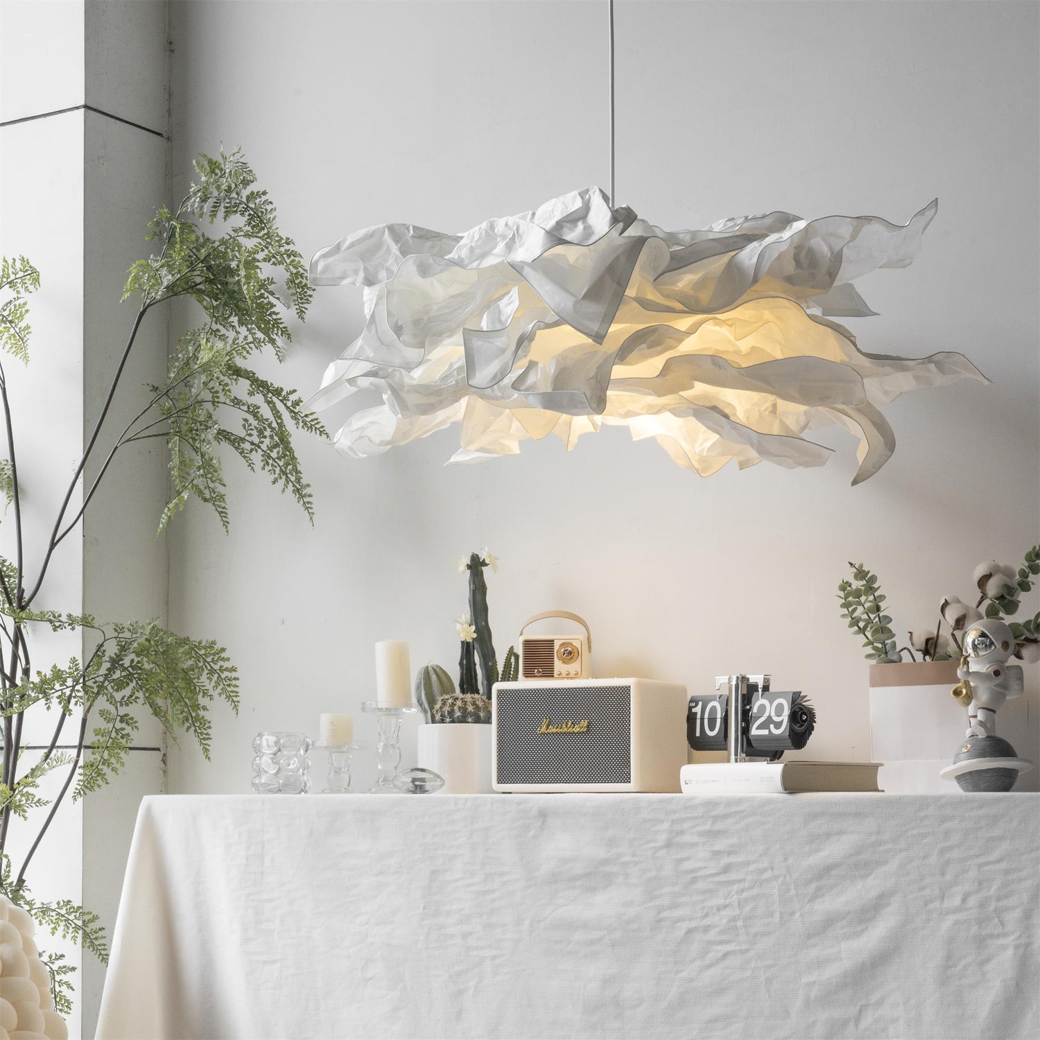 A pendant lighting suspension on a table