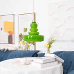 A green color pendant lighting hanging on a table